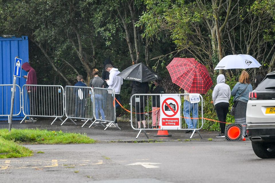 Locals queue to at the walk-up testing site at Caerphilly Leisure Centre