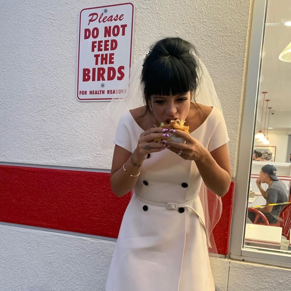 Lily Allen munching on a burger in her wedding dress