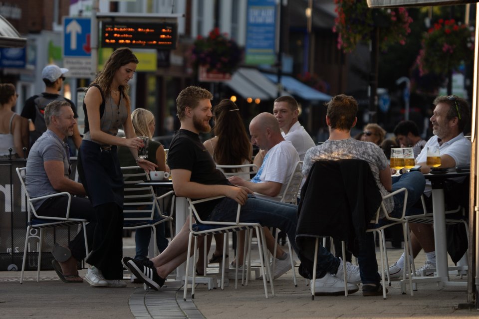 A waitress serves drinkers in Nottingham as they enjoyed their last pint before the 'rule of six'