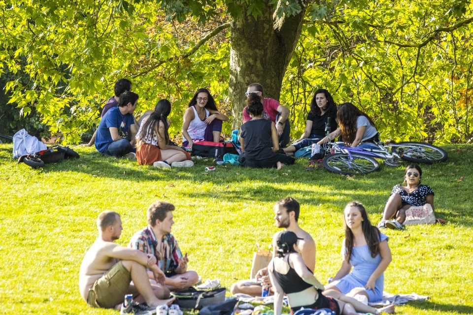 A large group relaxes in Castle Park in Bristol, risking a £100 fine