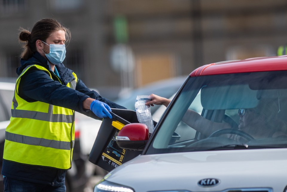 A test centre in Leicester with a member of the public dropping off a sample