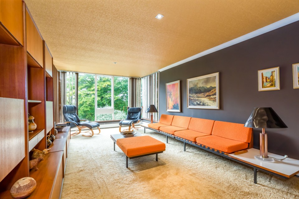 The home has been kitted out with orange sofas and shag carpets