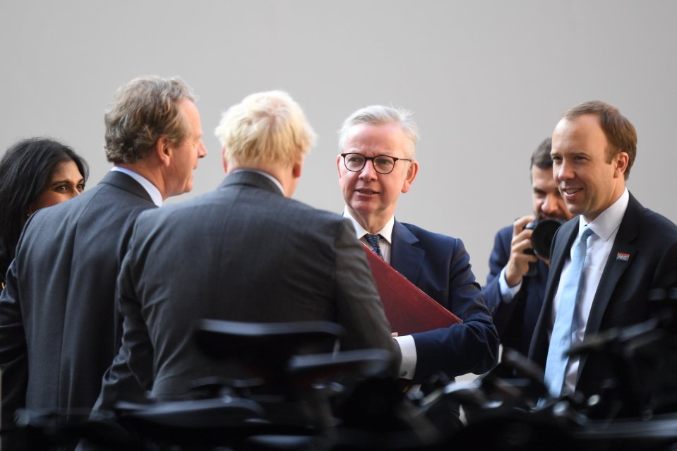 Boris Johnson speaking with Michael Gove and Matt Hancock after Cabinet