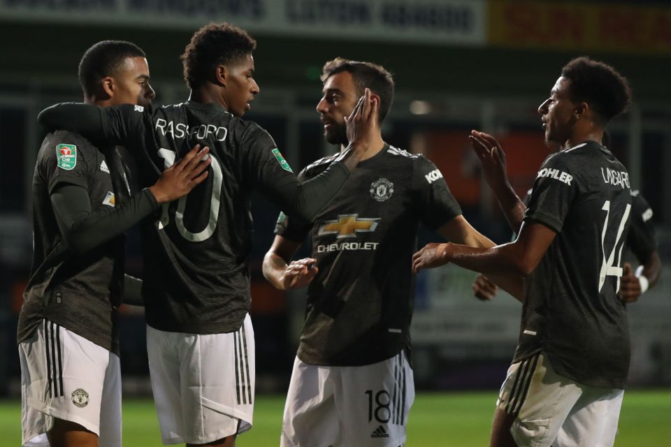 Marcus Rashford celebrates with team-mates after making it 2-0