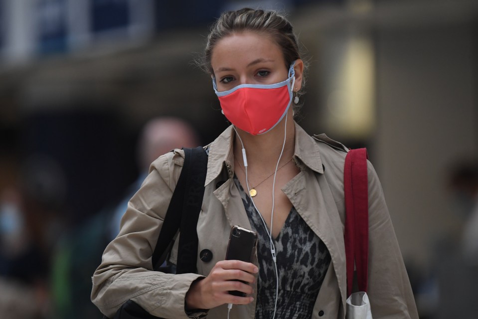 A woman wears a face mask at Waterloo station, London, to protect from Covid-19