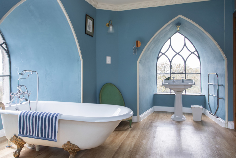 The bathroom has a roll top bath with views of the countryside