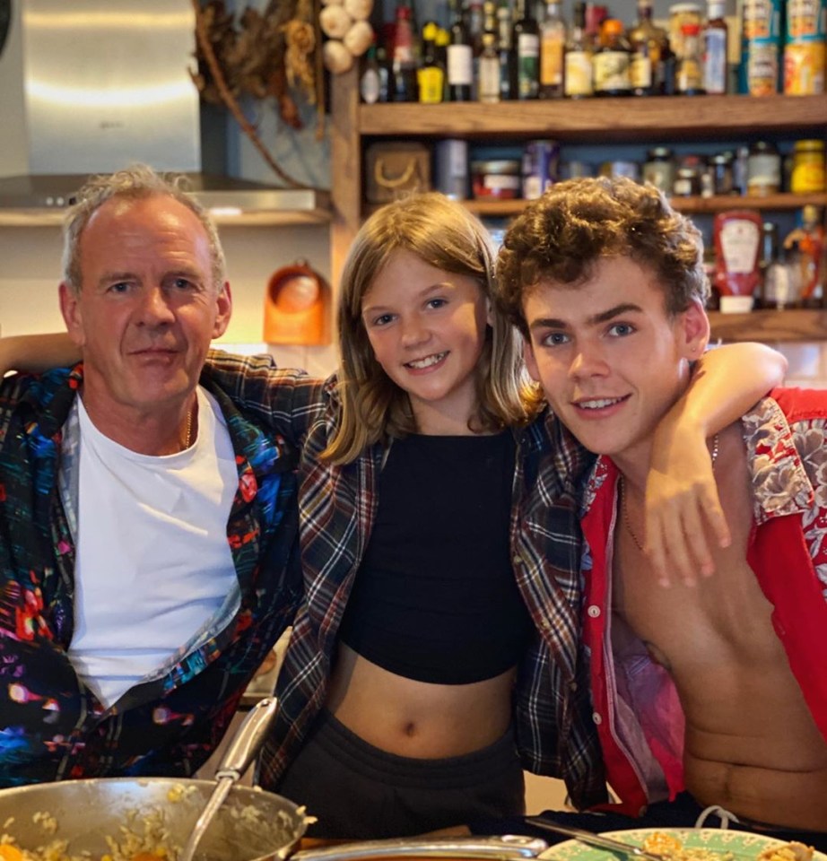 Woody posed alongside dad Norman and sister Nelly back at home