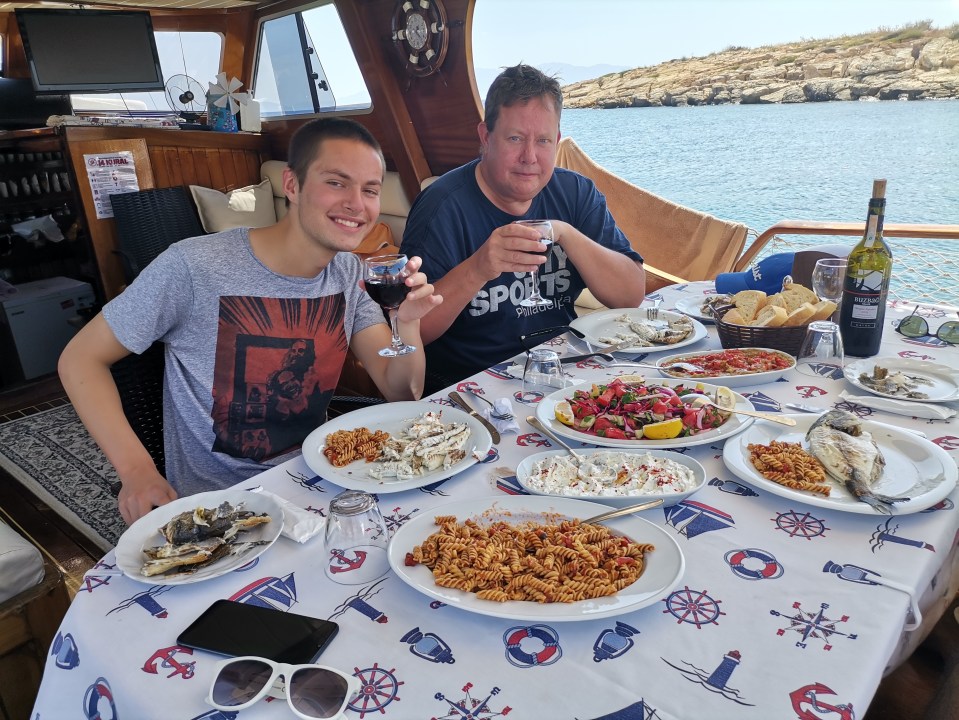 Neil and son Zak ditch their masks to enjoy a meal