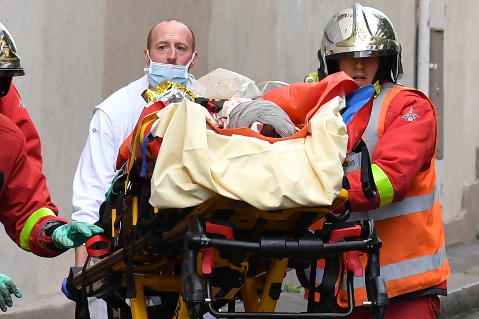 French firefighters load one of the three people injured into a waiting ambulance