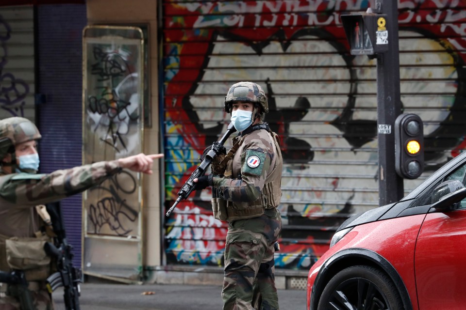 French soldiers stand guard near the scene