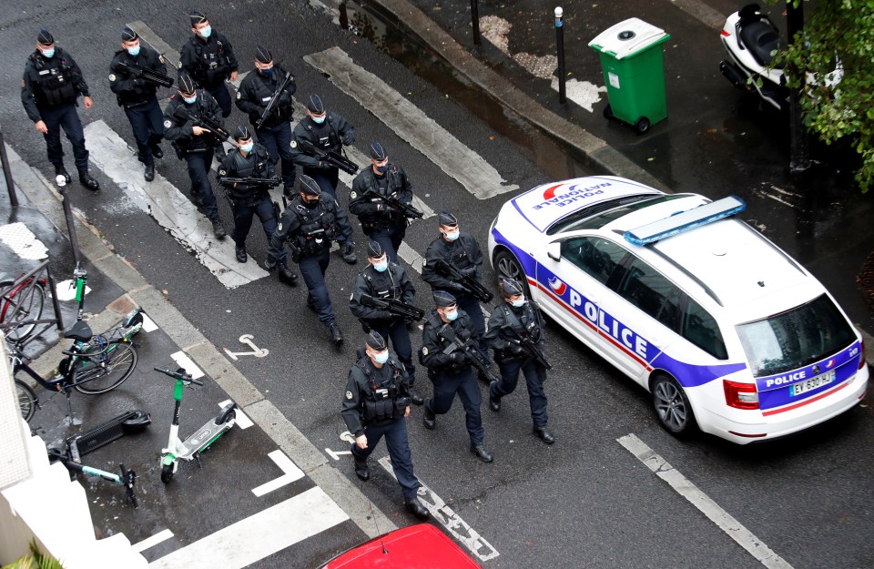 A full squad of armed police officers arrives at the scene