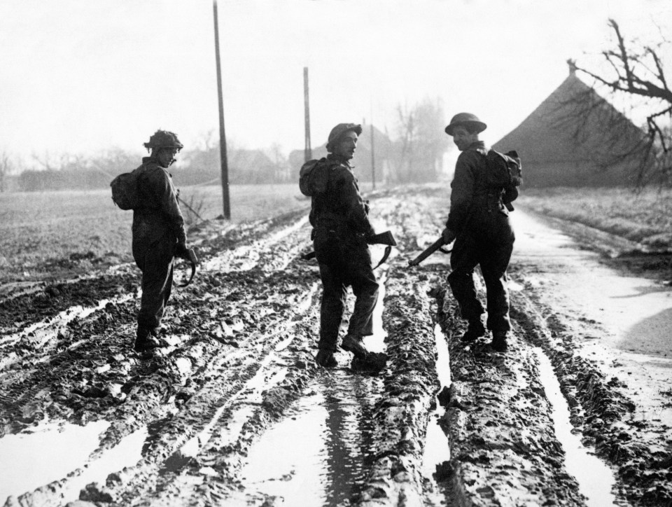 British troops walking to the front line through deep mud in Holland during the Second World War