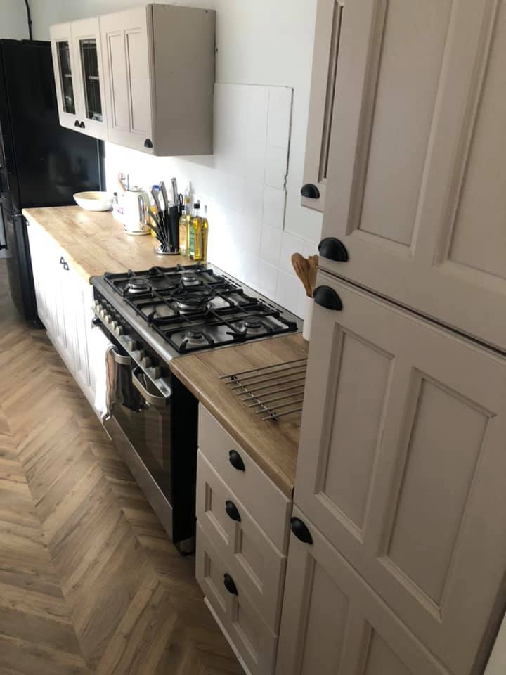 The kitchen was done on a budget using fablon and cupboard paint, with second hand appliances throughout 