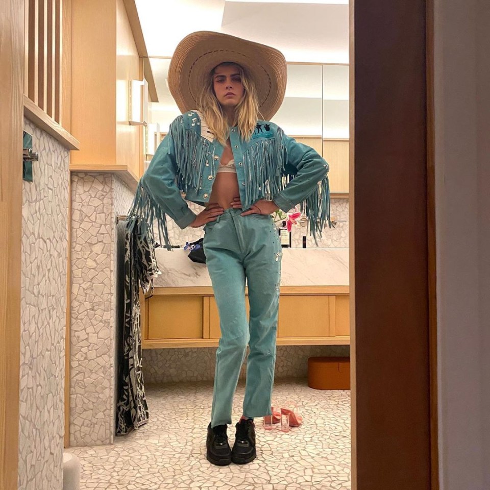 Model and actress Cara Delevingne teams her denim outfit with a giant sombrero