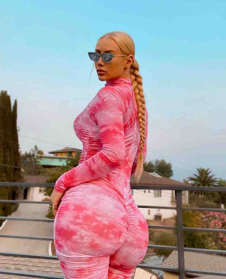 Rapper Iggy Azalea looks peachy as she poses in a skin-tight pink bodysuit