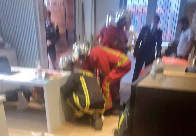 Picture showing emergency workers treating a victim in a nearby office