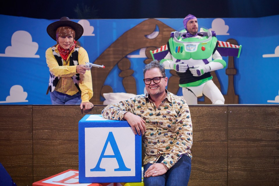 You’re never too old … Carr flanked by Toy Story’s Woody (Saunders) and Buzz Lightyear (Tom Allen)