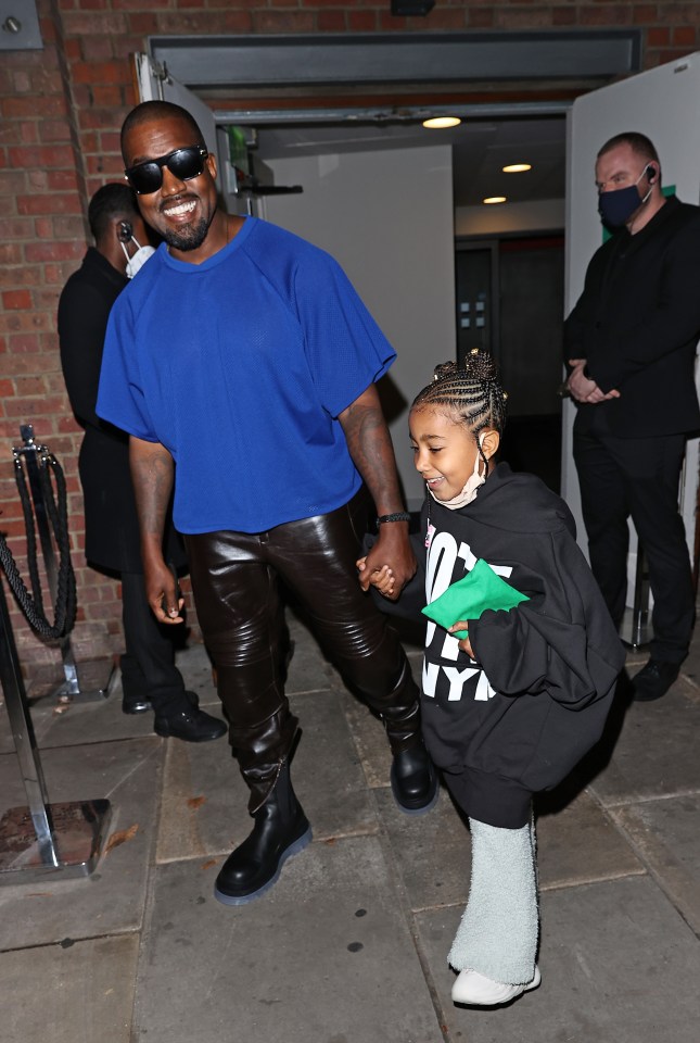 Kanye and daughter North are pictured out in London after flying in from LA