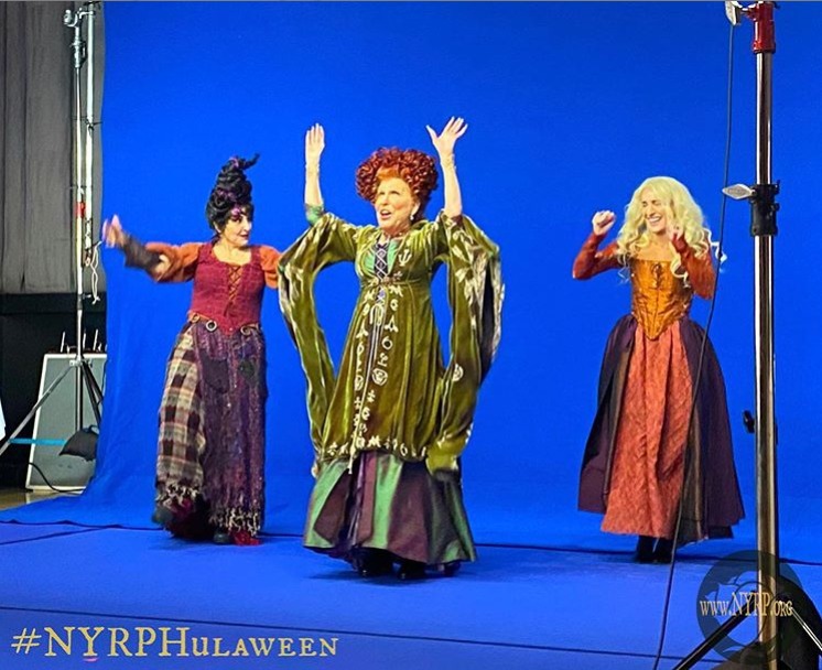 Bette posted a photo of the trio taking pictures in their witch costumes