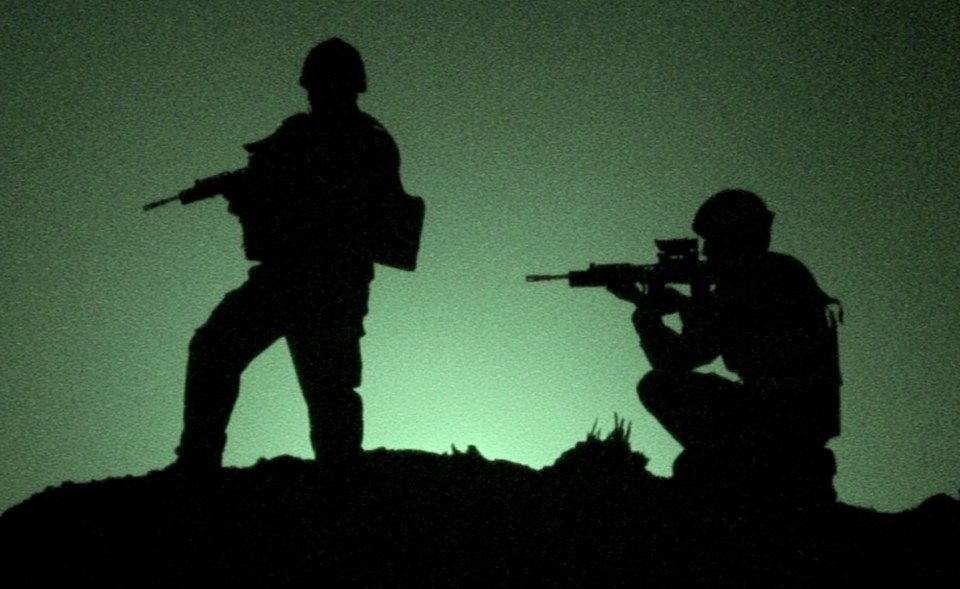 Silhouette of two soldiers on watch.