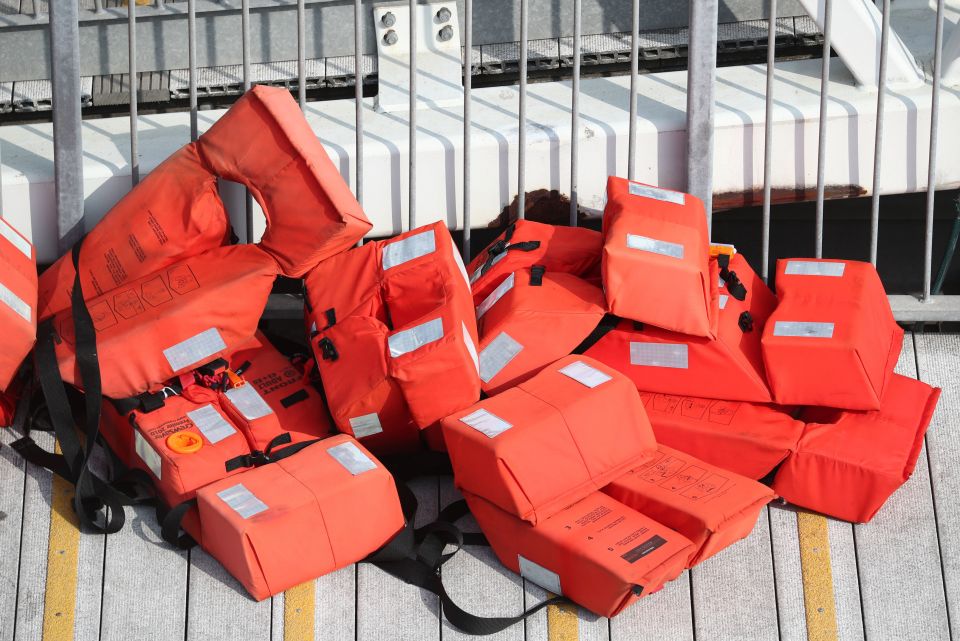 Vests, thought to be used by people attempting to get to the UK, are left on the quayside at Dover marina