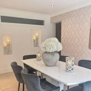 Soft grey chairs add an elegant touch to the dining room