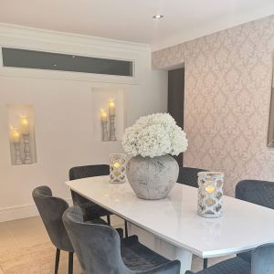  Soft grey chairs add an elegant touch to the dining room