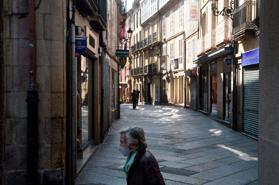 A woman walks in downtown Ourense, northwestern Spain, on the first day of a new lockdown this month