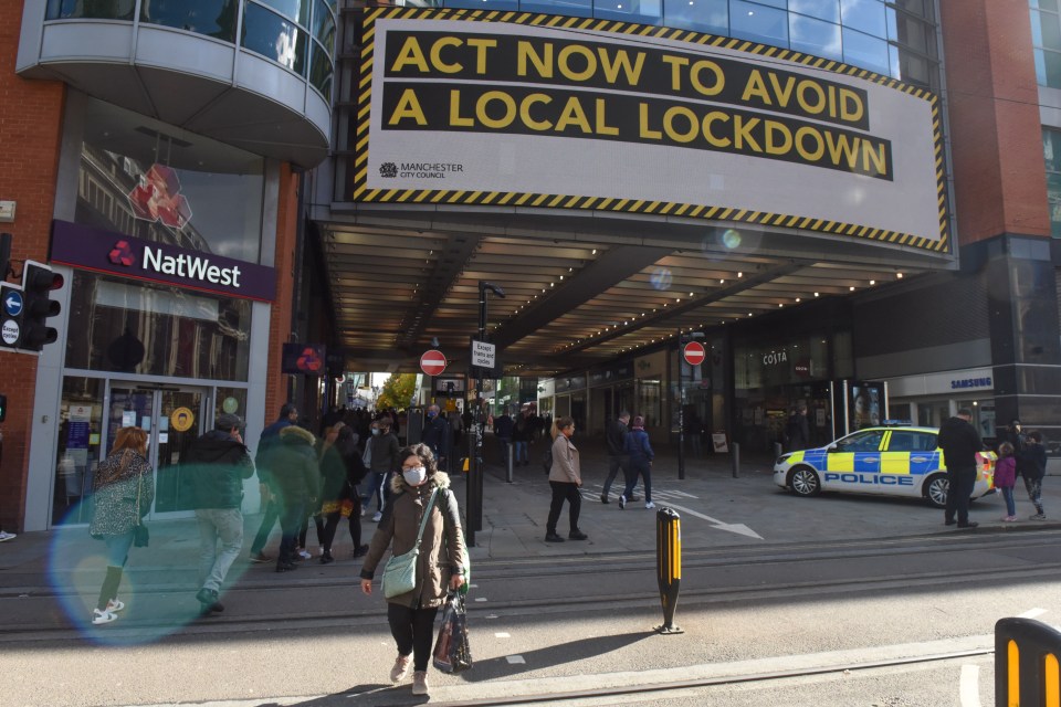 A sign in Manchester warns people to 'act now' in order to avoid a local lockdown