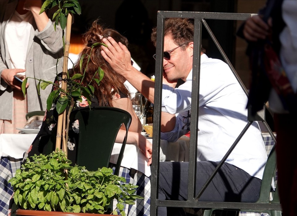 He was also caught stroking his co-star's hair 