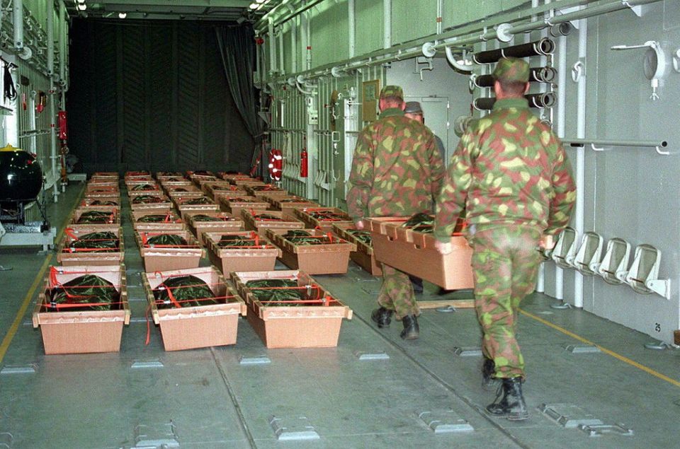 Finnish army recruits carrying the bodies of victims of the Estonia disaster on to a landing craft to be taken back to land