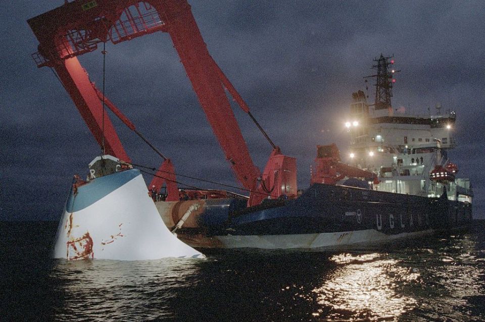 The bow door being recovered two months after the sinking - authorities say a problem with the door was to blame