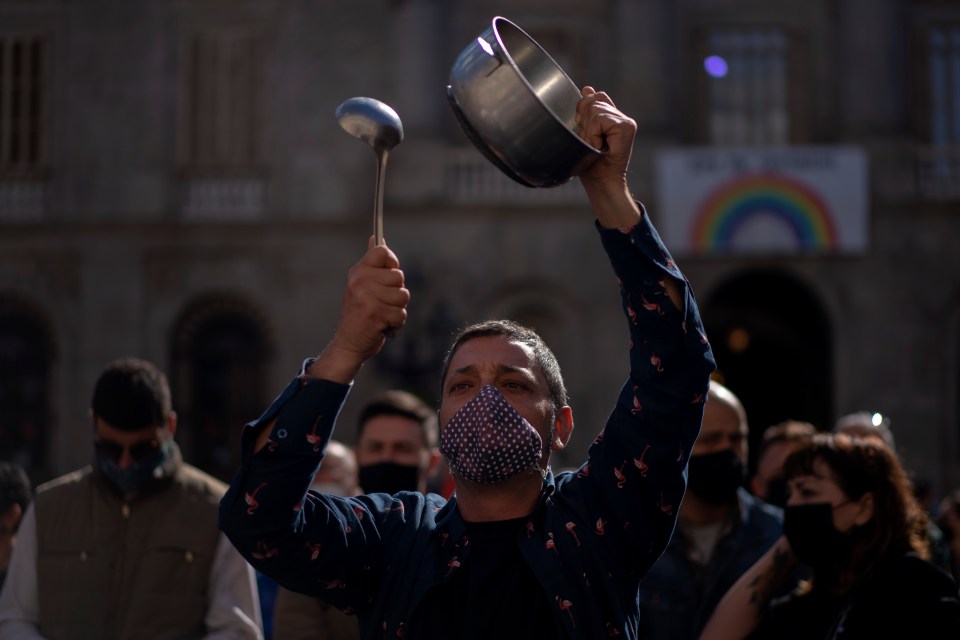 Demonstrators protest in Barcelona, Spain, on Wednesday Oct. 14, after authorities ordered shut all bars and restaurants for two weeks