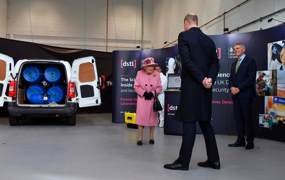 The Queen smiles as she meets with staff at the centre