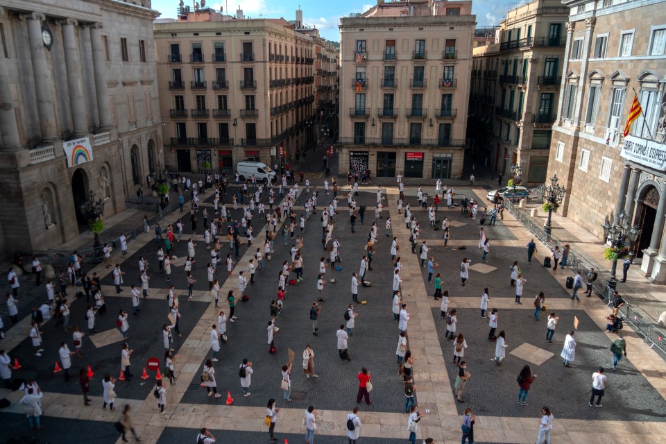 Medical residents take part on a protest against their working conditions during a strike in Barcelona, Spain, Tuesday, Oct. 20