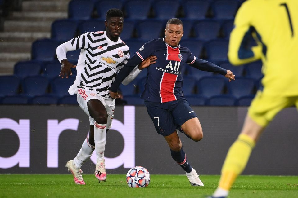 Man Utd youngster Axel Tuanzebe tussles with PSG star Kylian Mbappe