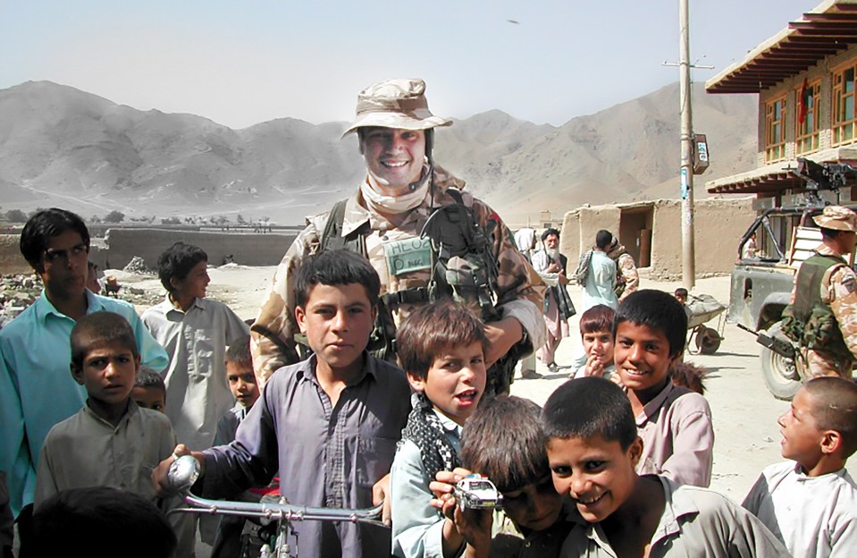 Heappey poses with local children in Afghanistan