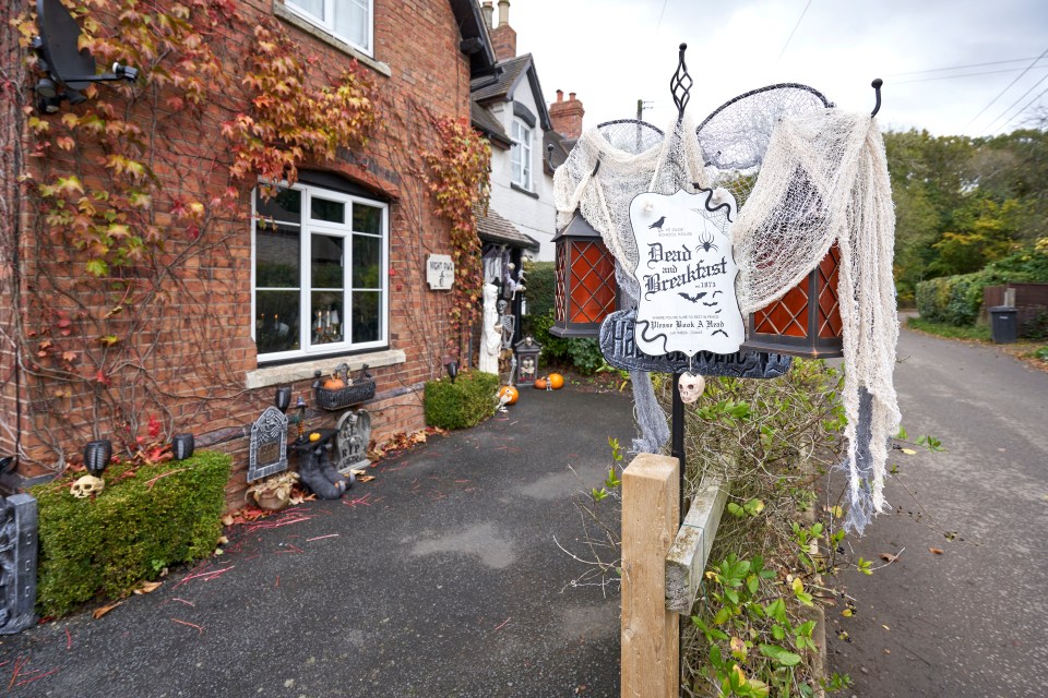 A spooky sign hangs outside Sue's 'haunted house'