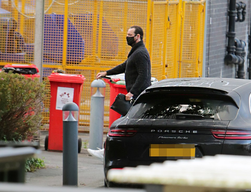 Danny Dyer in black and blue while wearing a mask