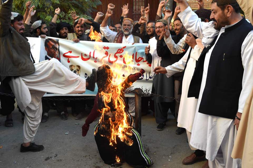 Protesters burn an effigy of Macron in Quetta, Pakistan