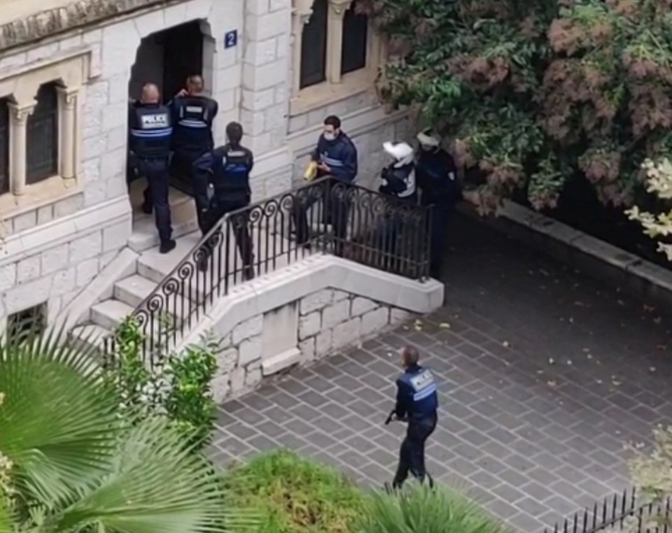 Police officers appear at the site of an attack at a church in Nice