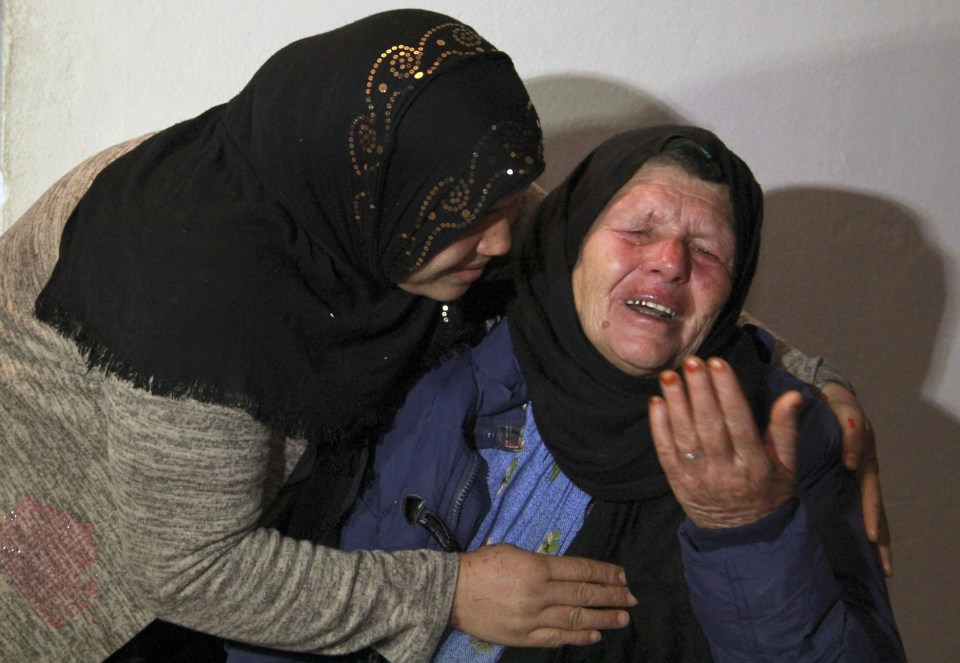 The mother of Brahim Aouissaoui cries at her home in Tunisia