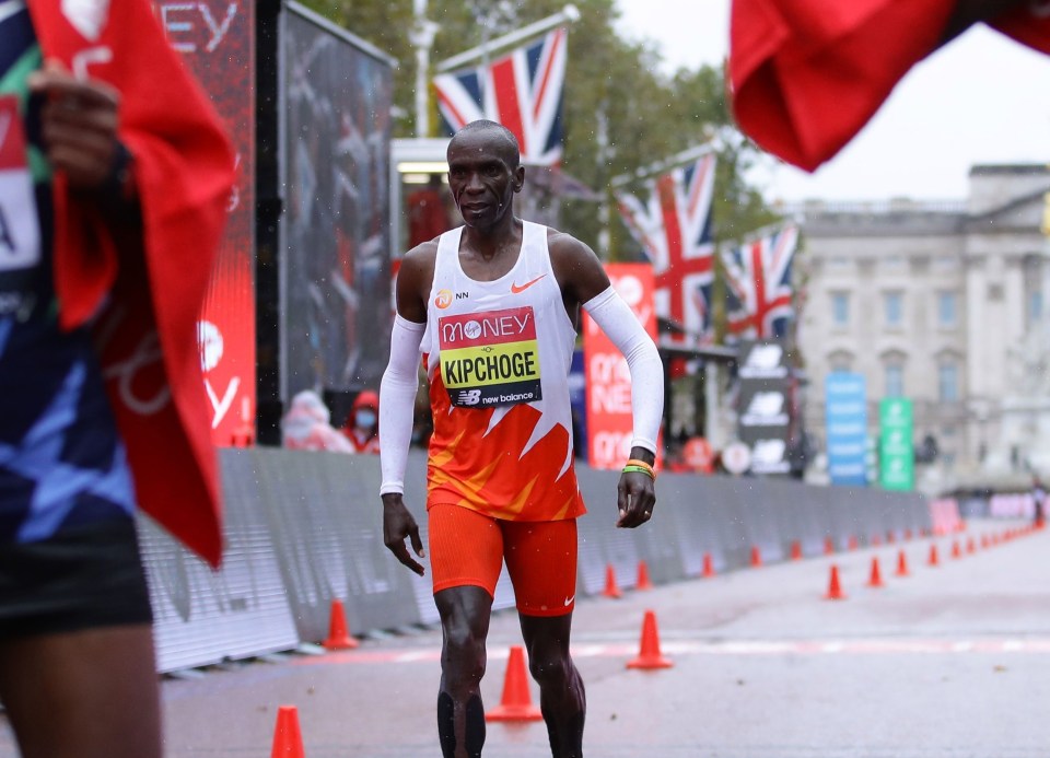 Kenya's Eliud Kipchoge wears his arms bands at the finish of the elite men's race of the 2020 London Marathon