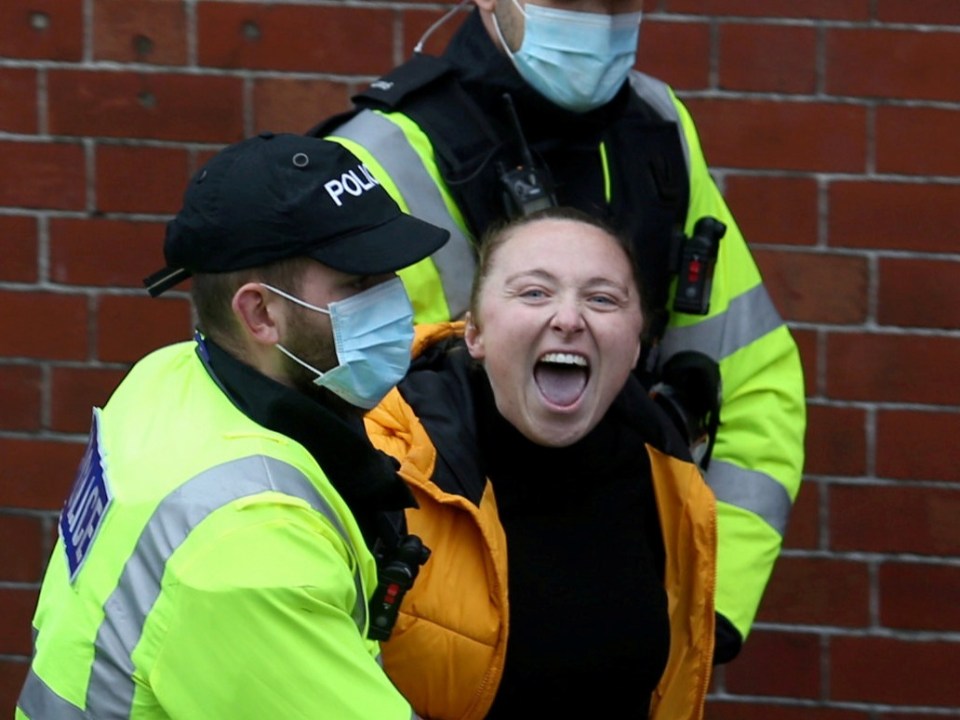 A woman is detained by police at the protest in Bristol 