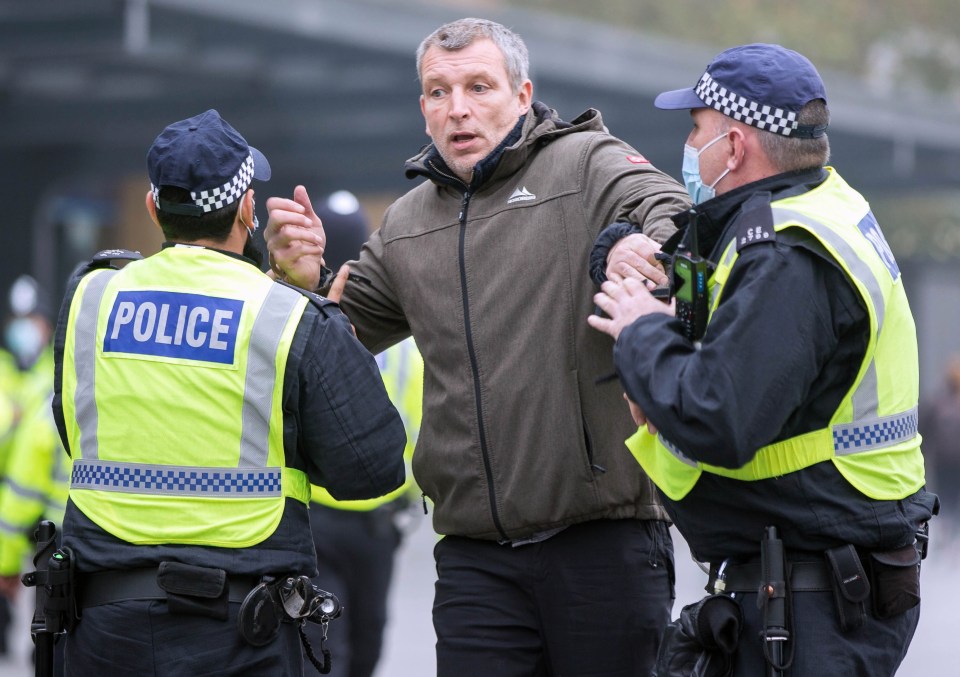 Police grab a protester in King's Cross, London