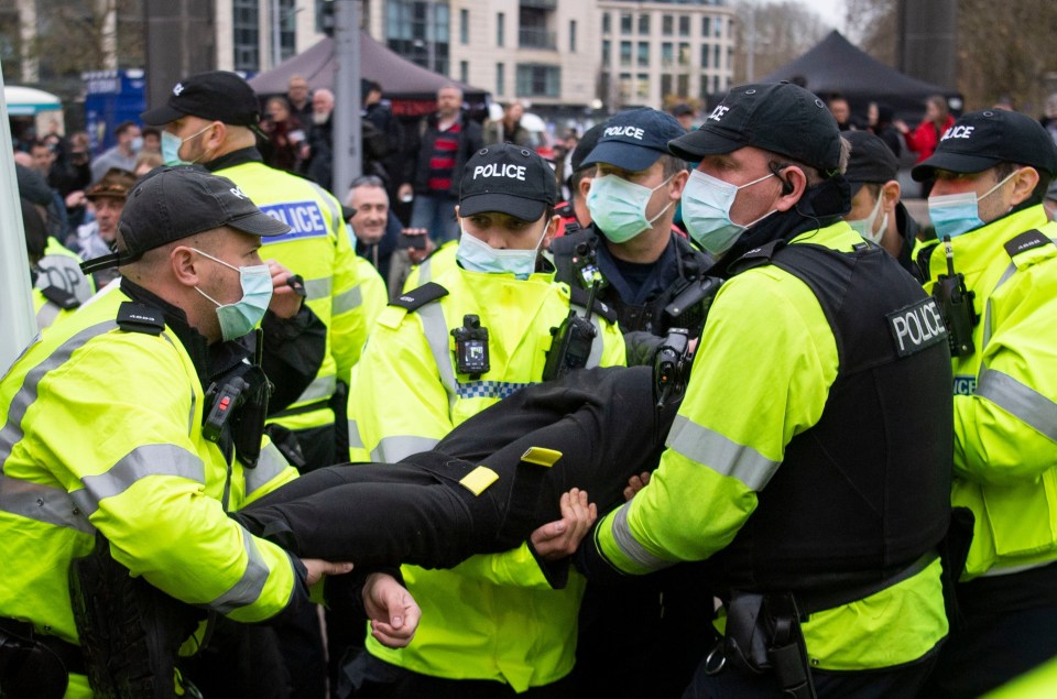 Police carry a person anyway from the march 