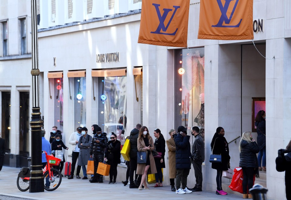 Shoppers queue outside the Louis Vuitton store on Old Bond Street