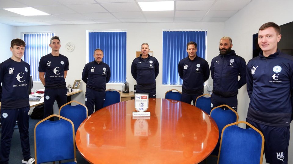 Darren Ferguson celebrates his SkyBet League One manager of the month award with his backroom staff at Peterborough