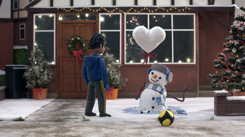 The little boy helps save a melted snowman