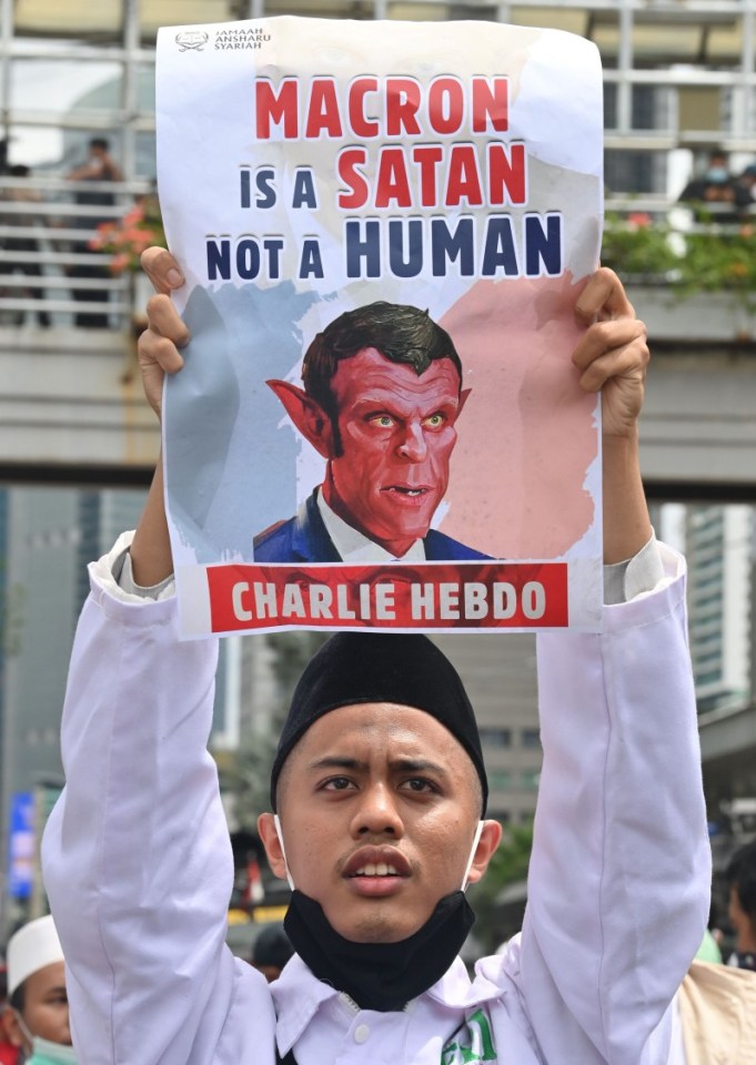 Some carried posters depicting Macron as the devil